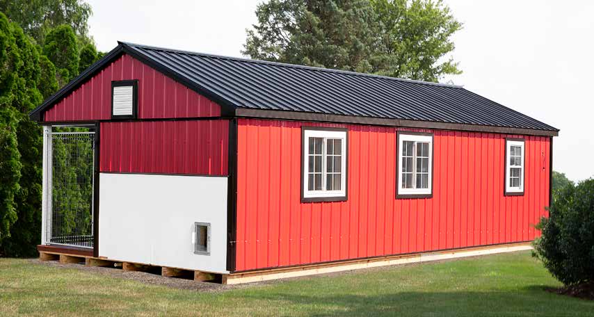 14x30 Commercial Kennel with red and white siding, black roofing, white trim, 5-boxes, and black trim.