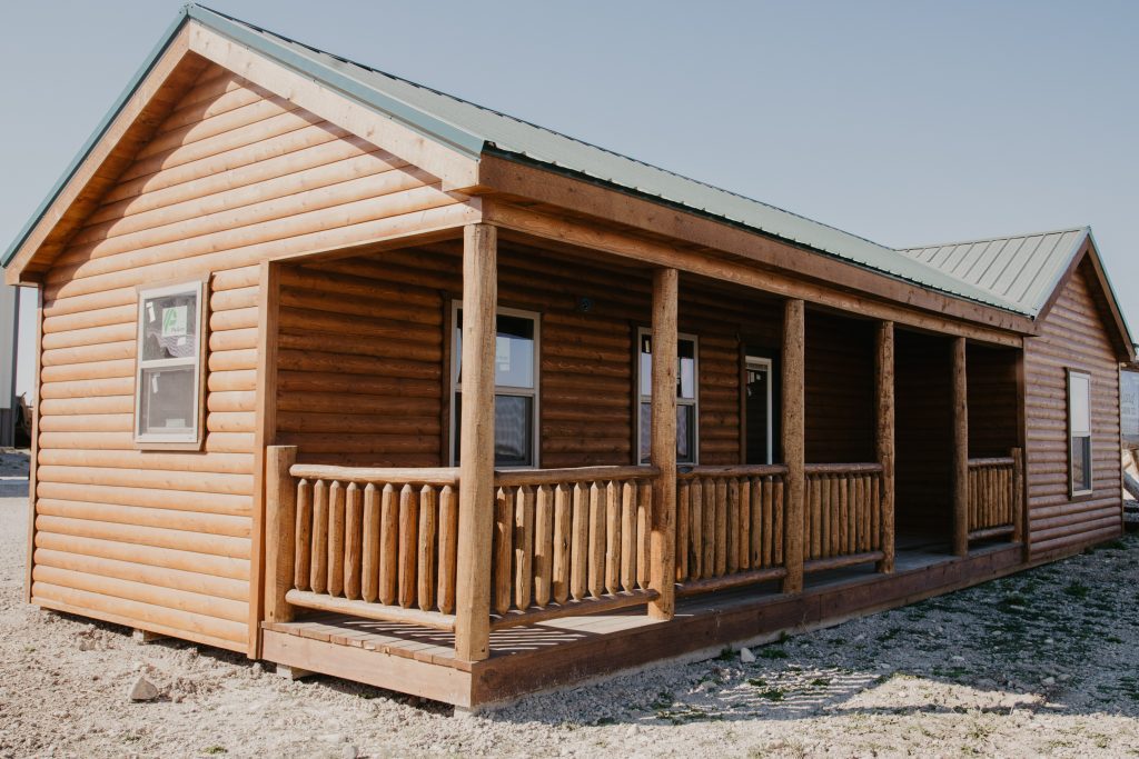 Front view of a Bridger Log Cabin with a front porch.