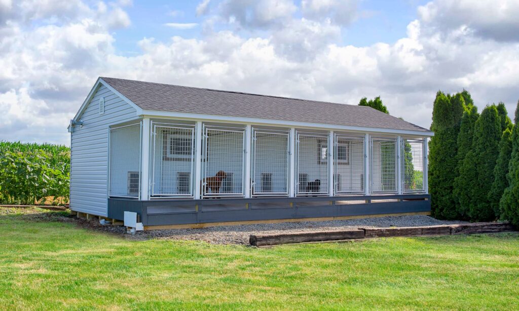 14x28 Commercial Kennel with 6 dog runs and white siding.