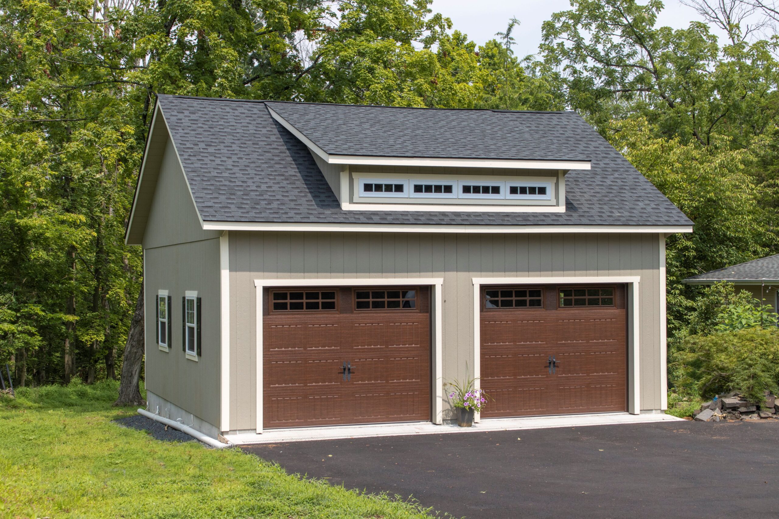 Exterior of a 2-story, 2-car Garden Shed Garage with gray siding and brown garage doors.