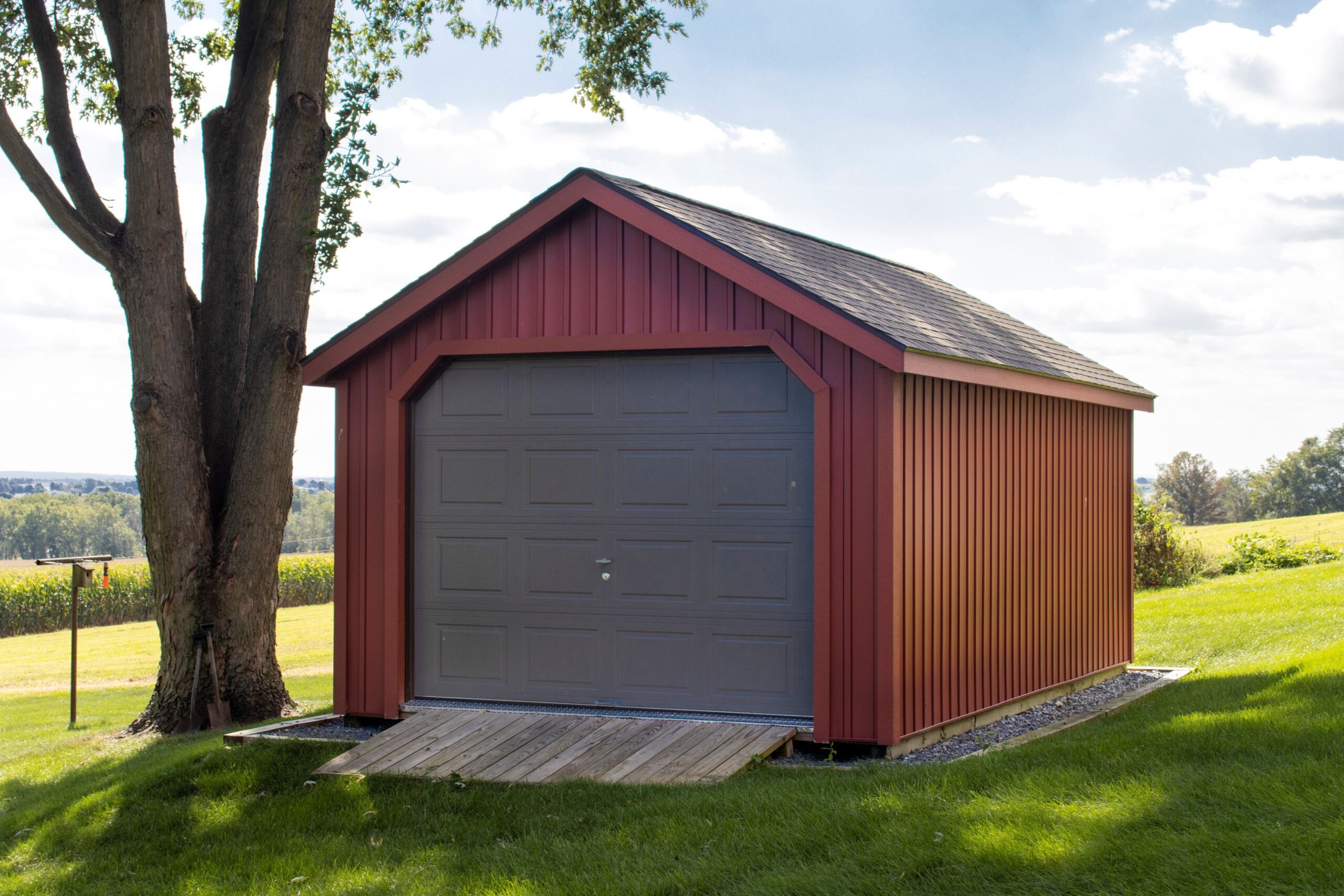 Exterior of a 1-story, 1-car Garden Shed Garage with red siding and a ramp.