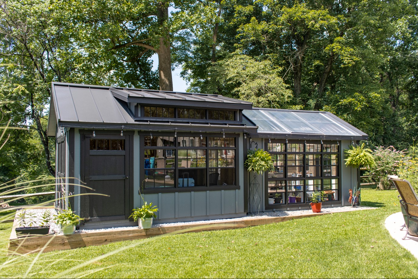 Exterior of a Combo Greenhouse with teal and black siding