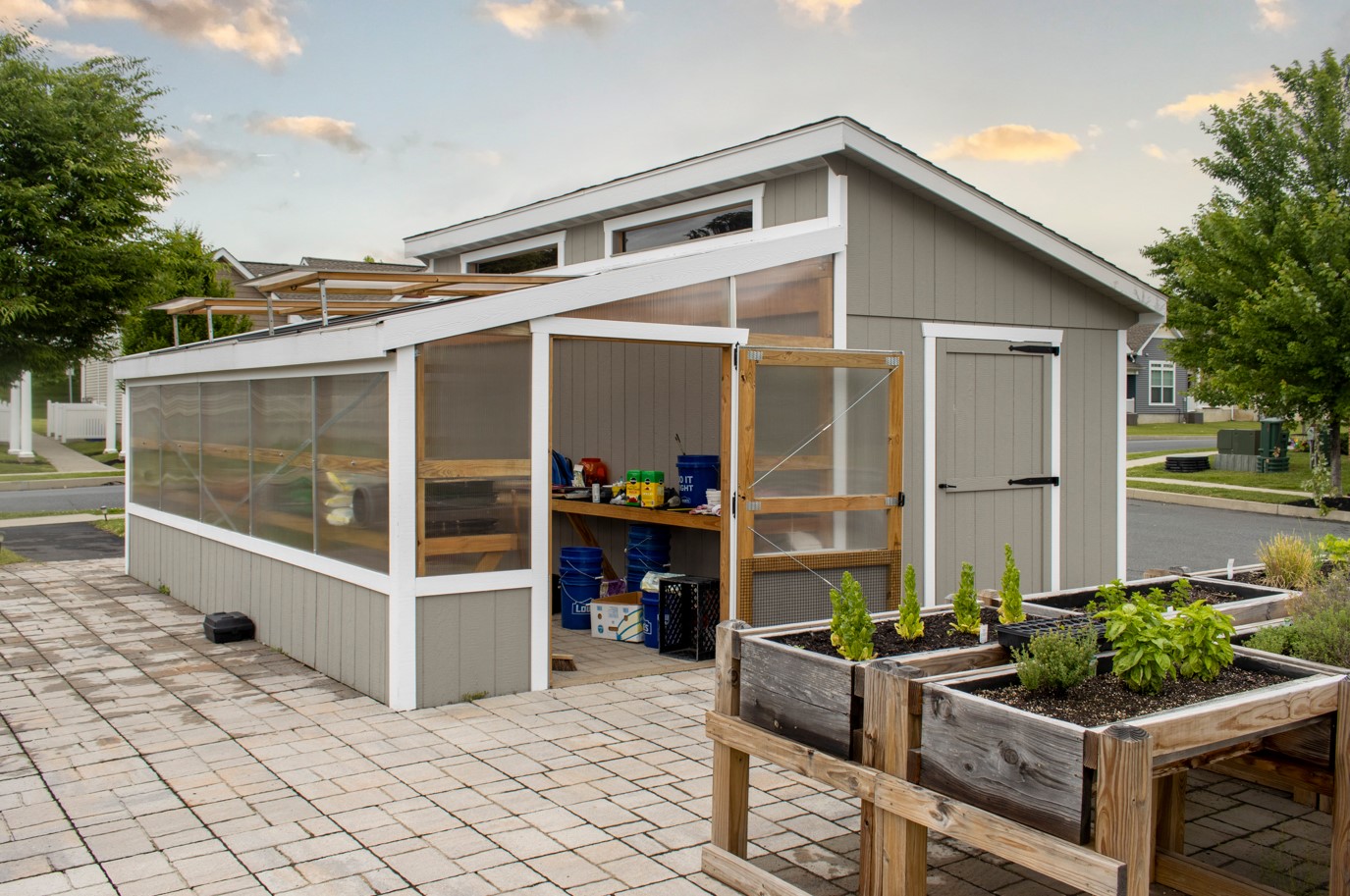 Front and side exterior of a white and gray Combo Greenhouse