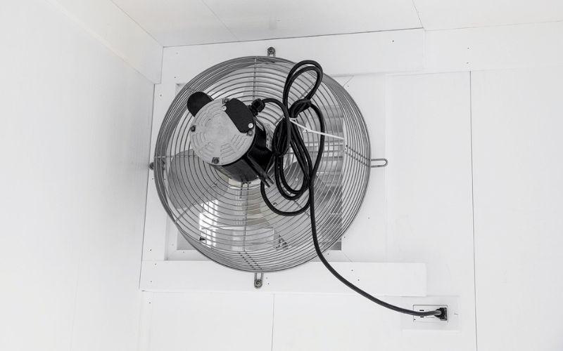 Close up of a 110-volt exhaust fan in a dog kennel