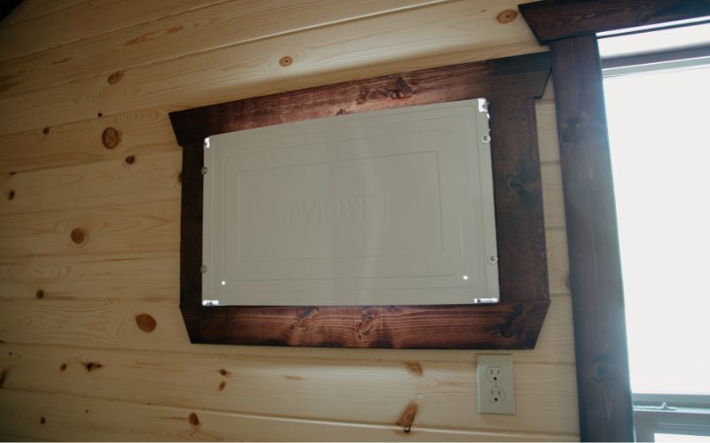 Cabin interior with a close up of an opening for AC and an outlet.