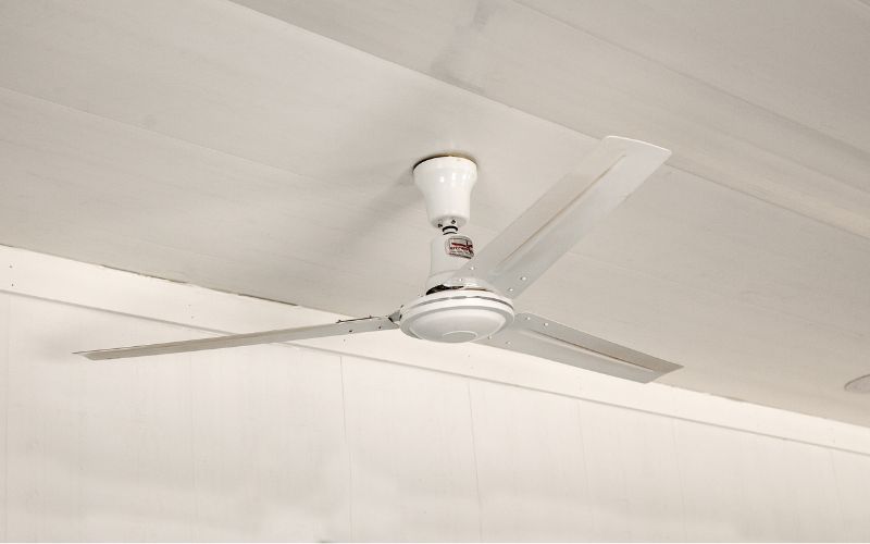 Close up of a white ceiling fan in a dog kennel