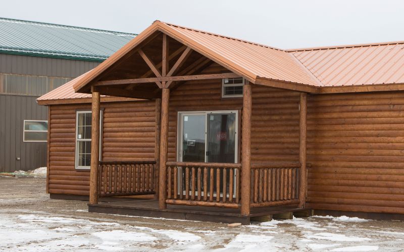 Exterior of a cabin with a detached a-frame porch