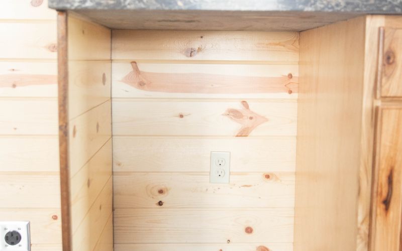 Close up of a dishwasher cabinet opening in a cabin