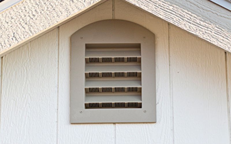 Close up of a tan gable vent on a dog kennel