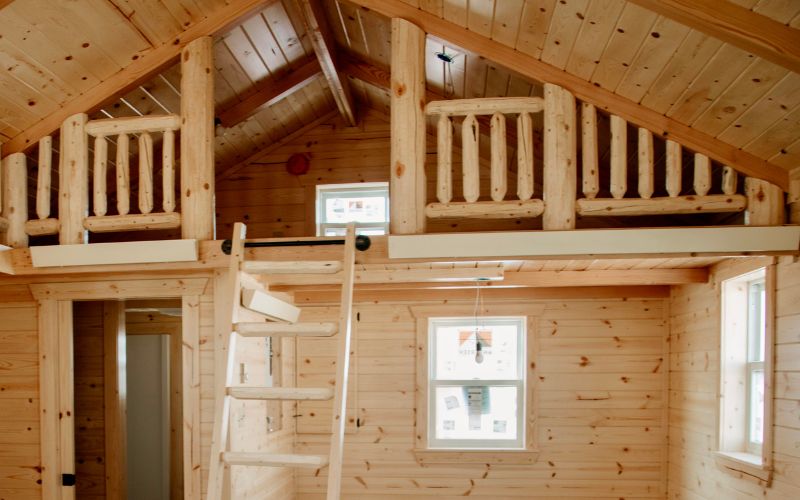 Interior of a cabin with a loft and ladder