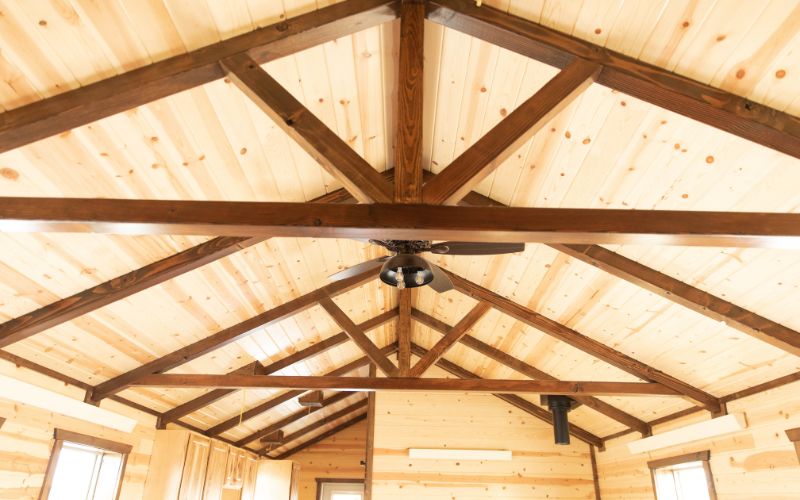 Close up of a cabin ceiling with stained beams