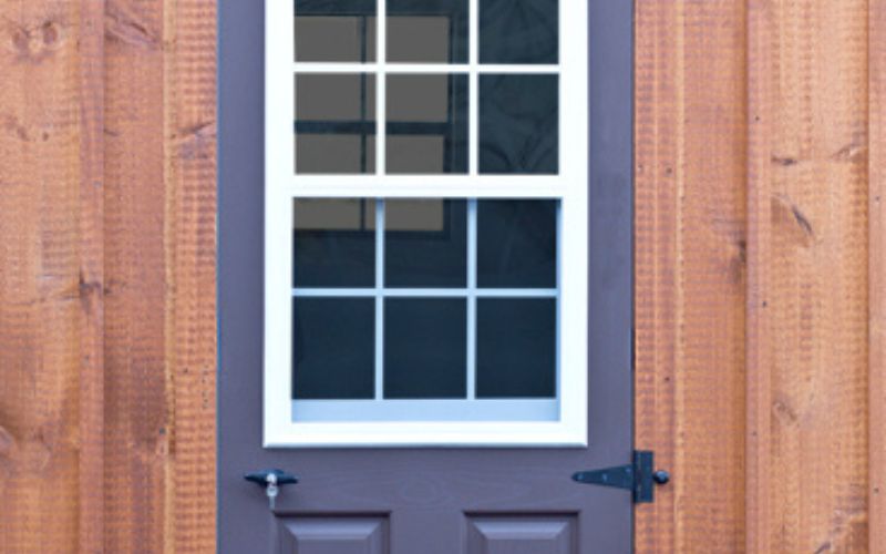 Close up of a blue vent lite slab door on a dog kennel