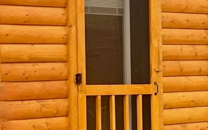 Close up of a wood screen door on a cabin