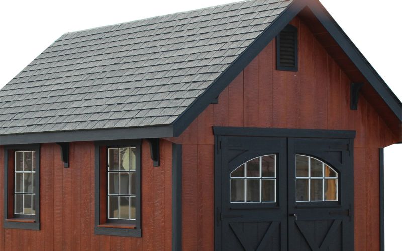 12 inch overhangs on a garden shed with brown wood siding, black trim, and a black roof