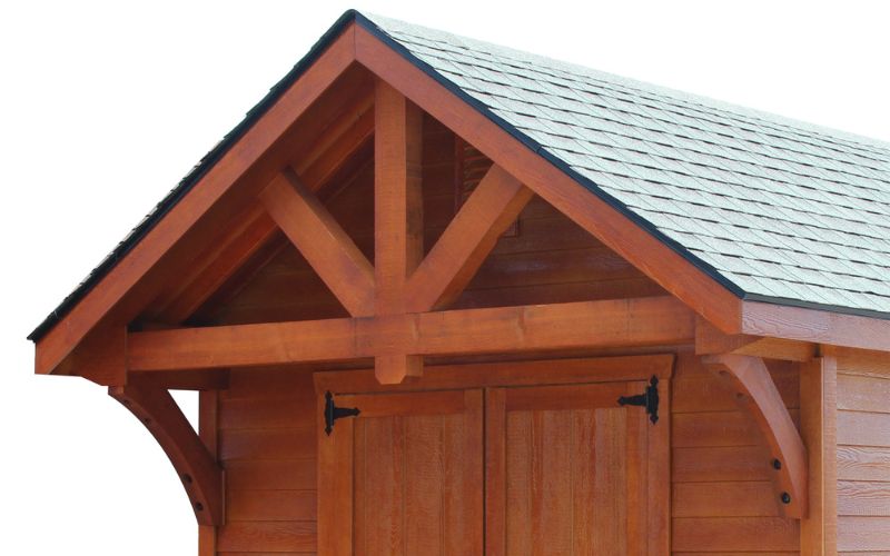 2 foot Alpine Gable Overhang on a shed with reddish-brown stain and a green roof