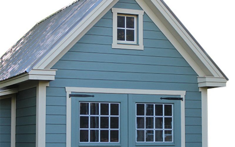 Close up of white colonial trim on a blue shed