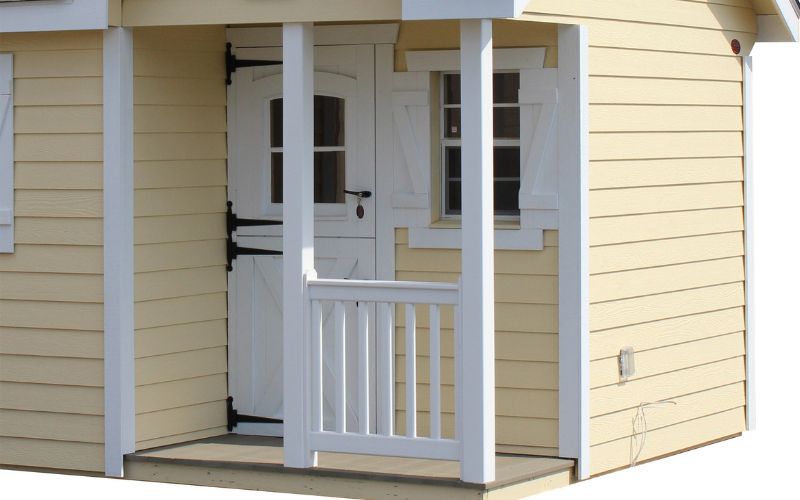 Close up of a corner porch on a yellow and white shed