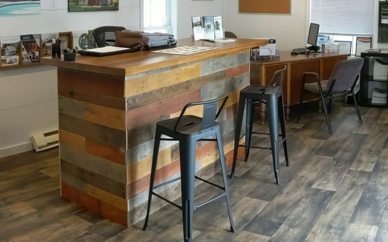 Home office interior with black counter stools and a multi-colored wood pallet counter