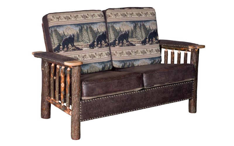 Wood base loveseat with 2 bear patterned back cushions, 2 brown leather seat cushions, brown leather arm rest padding, and brown leather accents