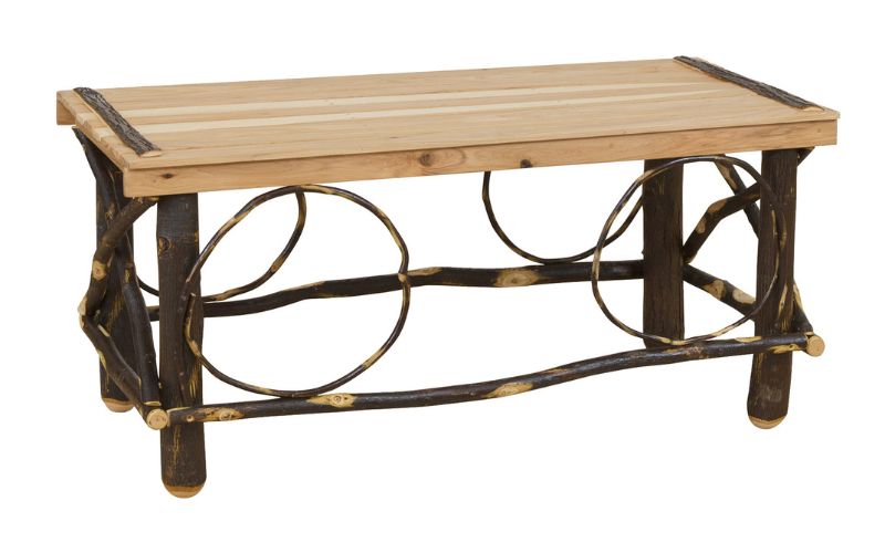 Coffee table with a slat top, branch legs, and twig decorative accents