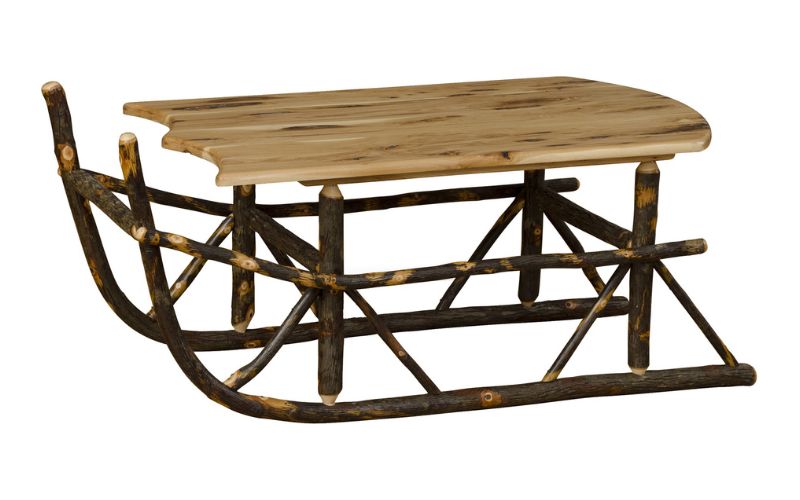 Coffee table shaped like a sleigh with a light wood top and dark wood base