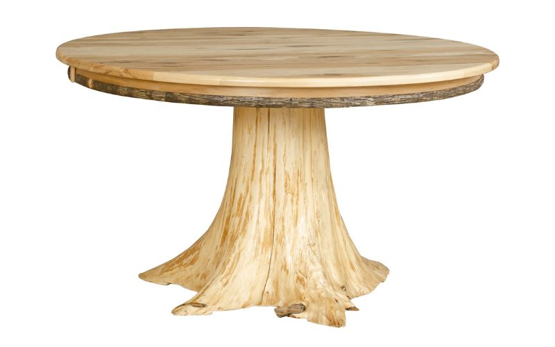 Round dining table with a light-colored wood top and a natural tree stump base