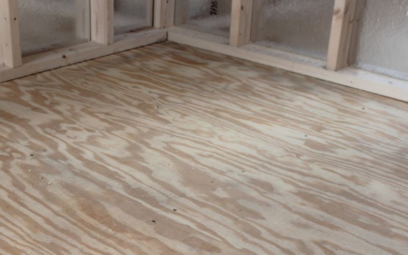 Close up of a shed's floor with plywood flooring