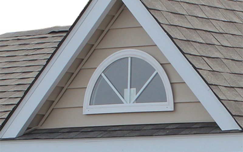 Close up of a half-round vinyl insulated window in white