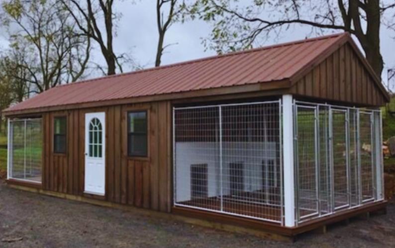 Front and side view of a custom 12x32 Commercial Kennel with chain link dog runs and brown wood siding.
