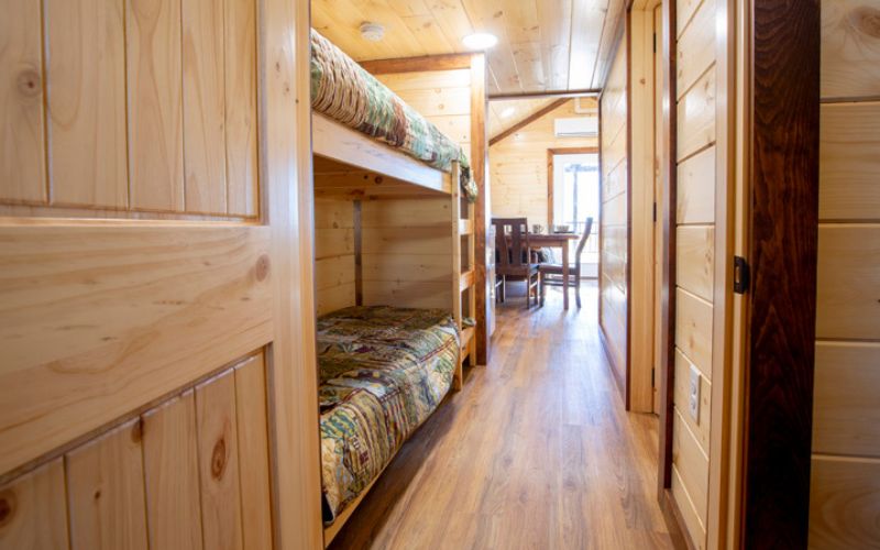 View down a hallway with a set of bunk beds built into the left wall.