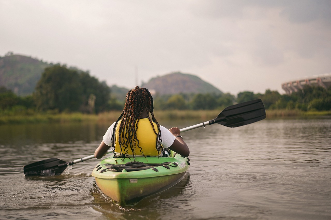 woman in a green kayak on a lake