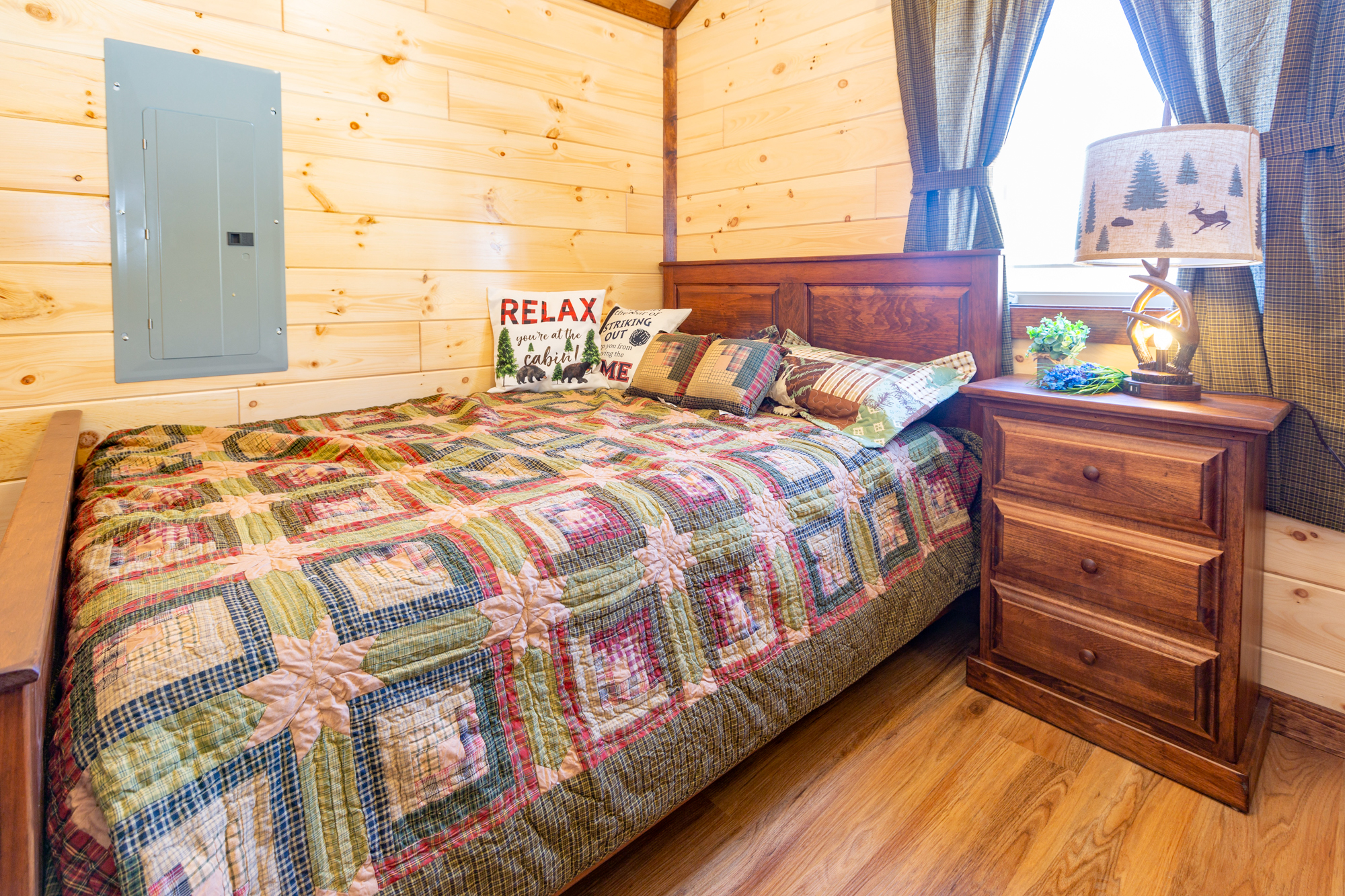 master bedroom with queen bed and nightstand