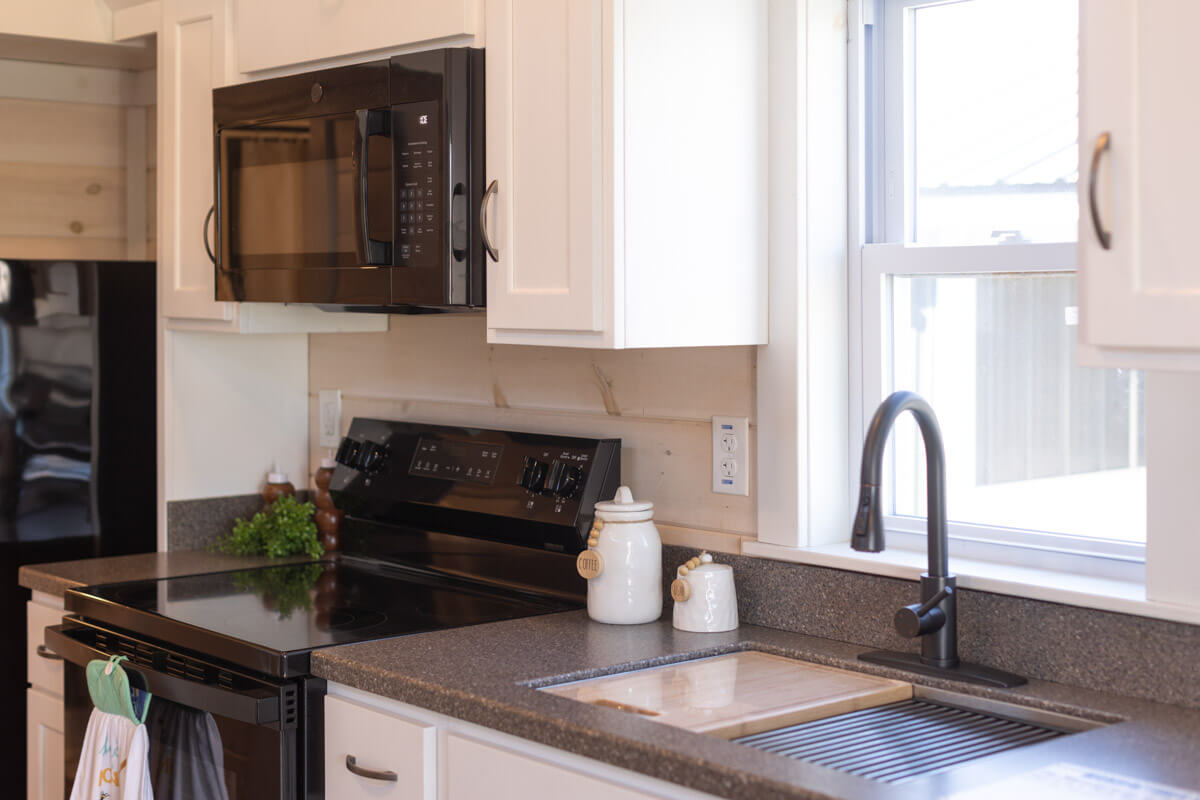 kitchen countertops, with sink, stove, and microwave